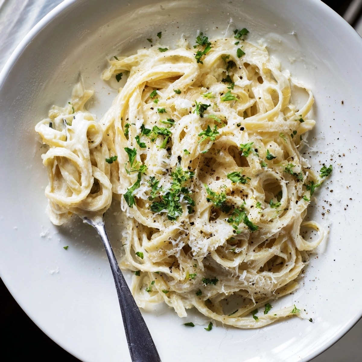 A bowl of flavorful Lemon Ricotta Pasta: al dente noodles glistening in a smooth, cheesy sauce.
