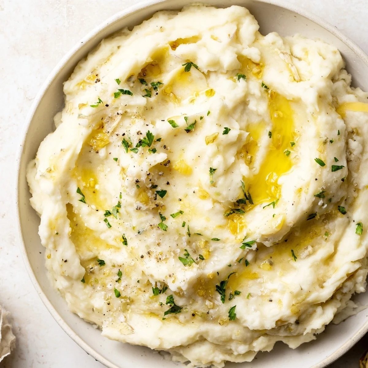 Fluffy, creamy Garlic Parmesan Mashed Potatoes, perfect alongside a juicy roasted chicken and fresh herbs.
