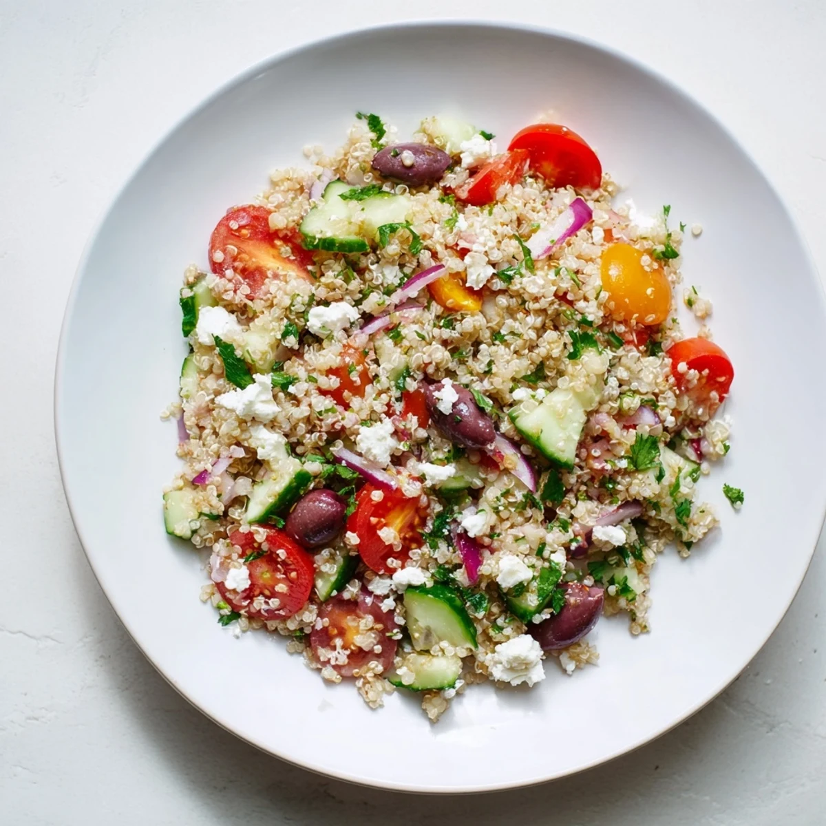 A colorful Mediterranean Quinoa Salad with crumbled feta, ready for a fresh, healthy meal.