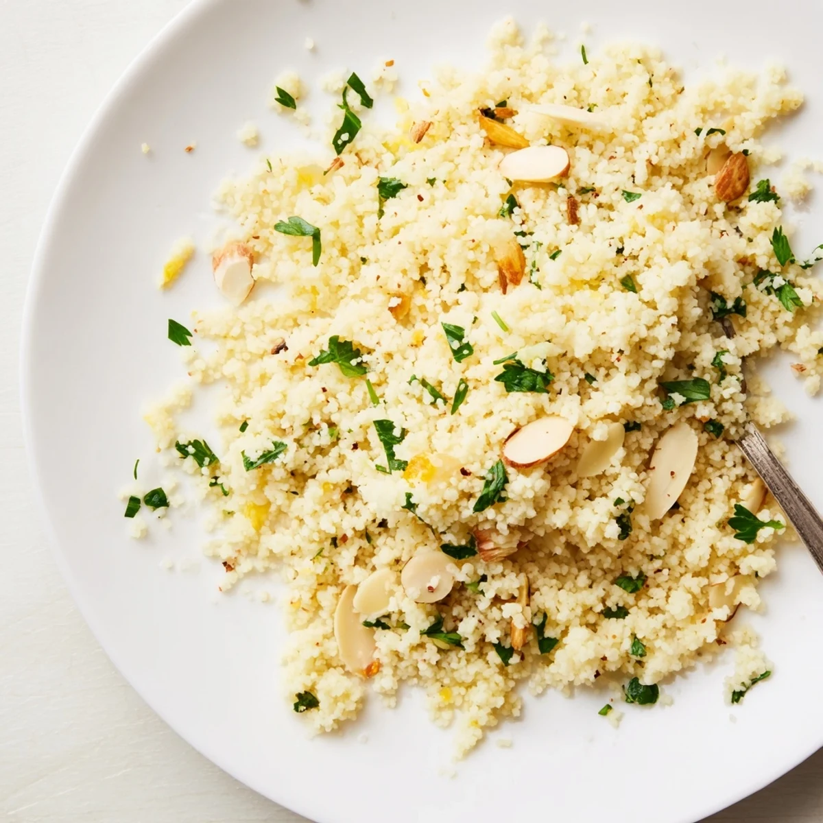 Fluffy couscous, a simple North African side dish, ready to be served with fresh herbs.