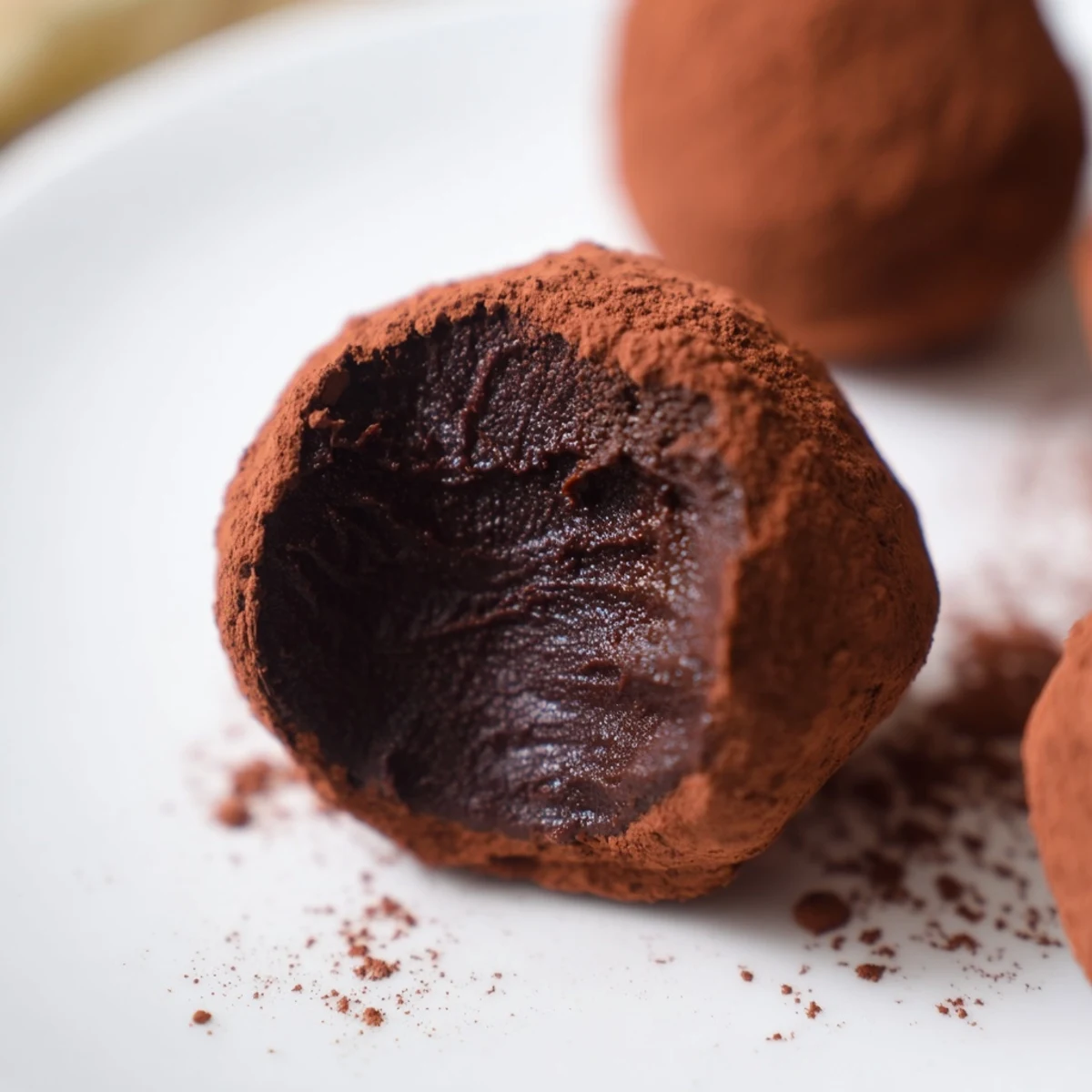 Rich, dark truffle chocolates coated in cocoa powder, a luxurious dessert treat ready to enjoy.