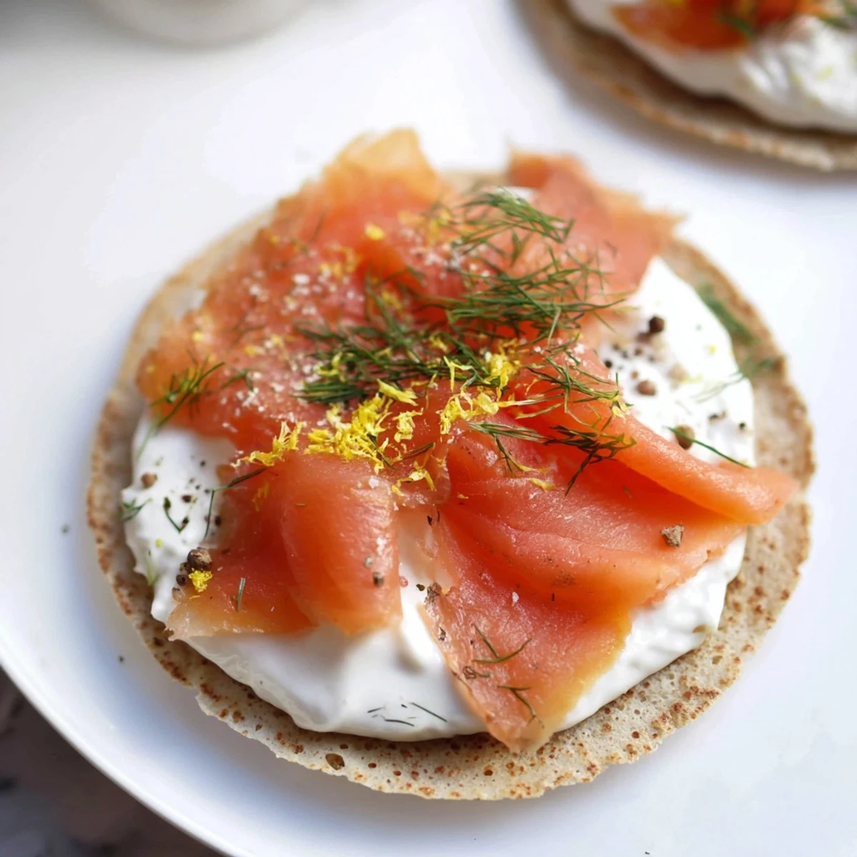 Golden-brown Smoked Salmon and Cream Cheese Blinis, beautifully arranged for an elegant appetizer.