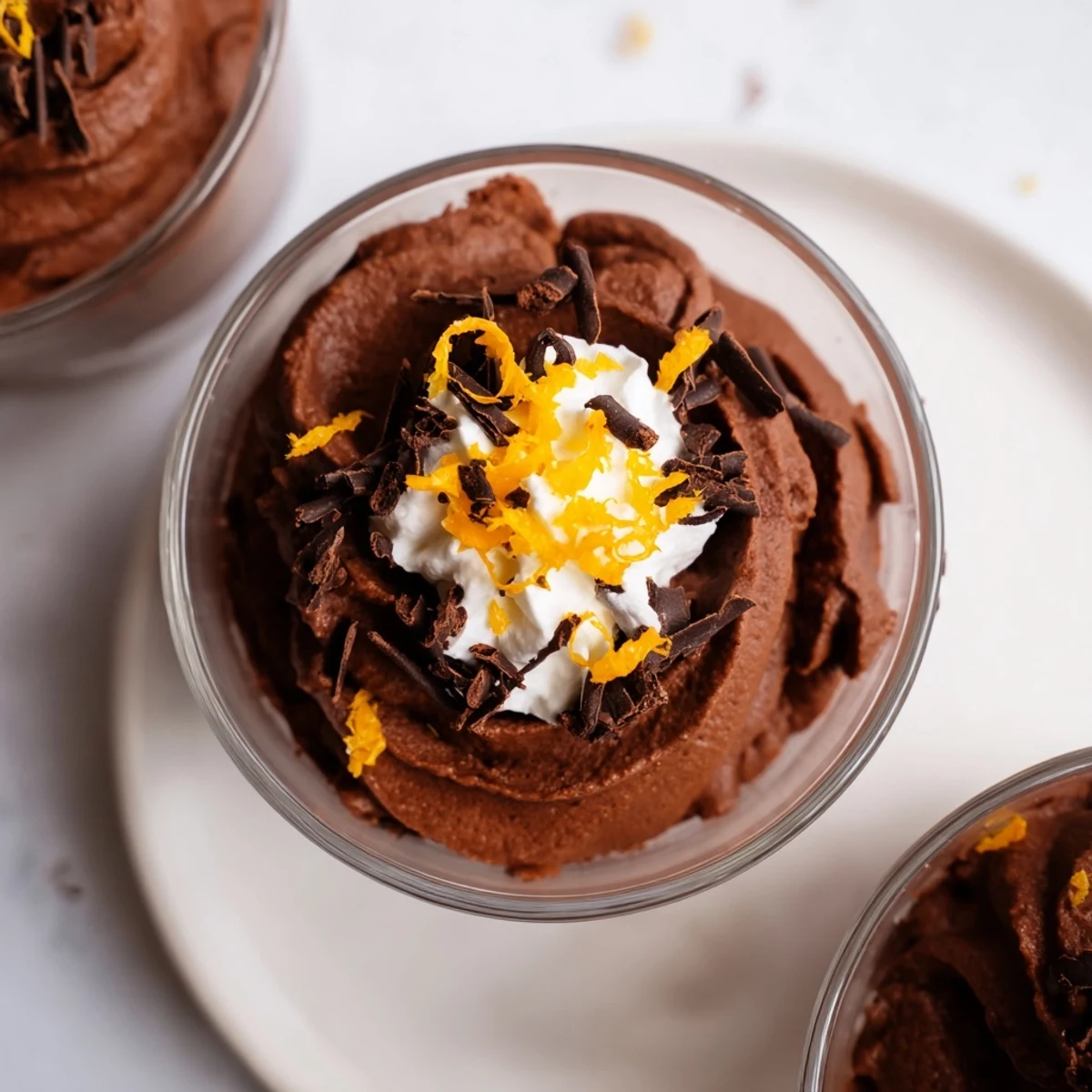 Rich, dark chocolate and orange mousse, swirled with whipped cream, a luxurious French dessert.
