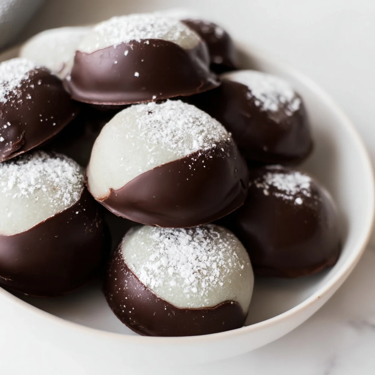 A close-up of festive Peppermint Creams, smooth and white, perfect for gifting this holiday season.