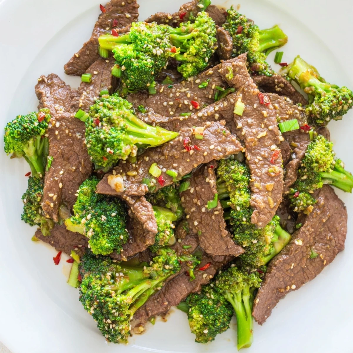 Freshly cooked Keto Friendly Beef and Broccoli Stir Fry served on a white plate.