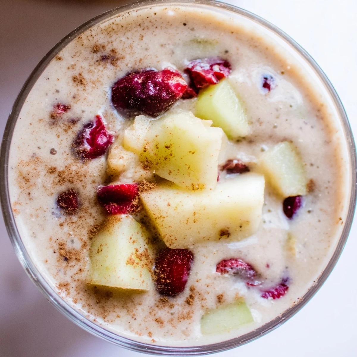 Vibrant Winter Smoothie Blend in a glass, creamy and swirled with cinnamon and nutmeg, topped with chia seeds.