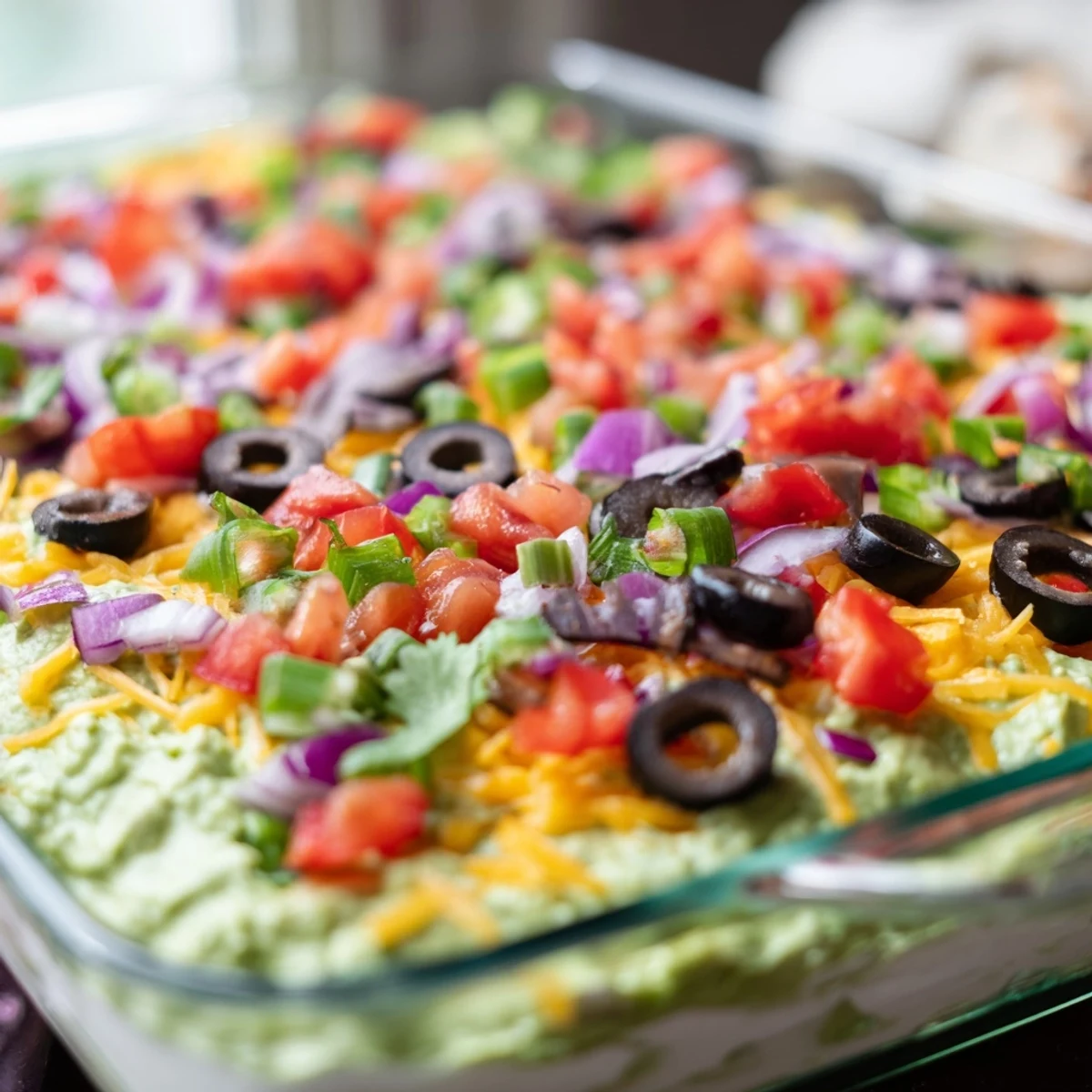 This colorful Touchdown Tex Mex Layer Dip features creamy beans, melted cheese, fresh tomatoes, and olives for game day.  