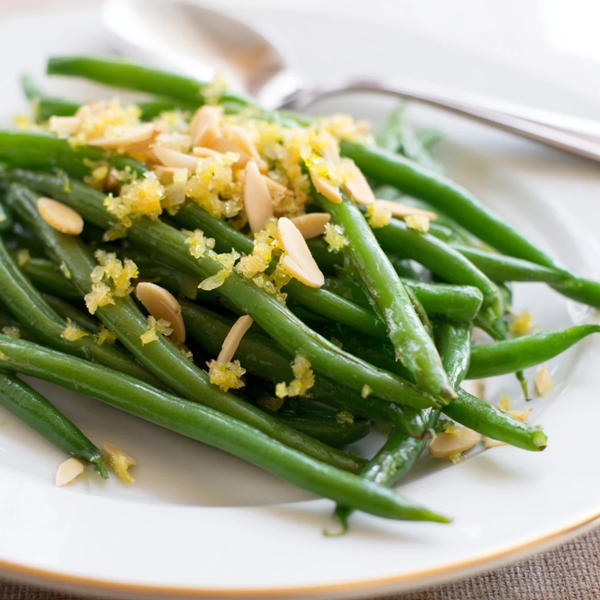 Crisp-tender green beans with golden almonds and minced garlic, a gluten-free vegetarian side perfect for a weeknight dinner plate.