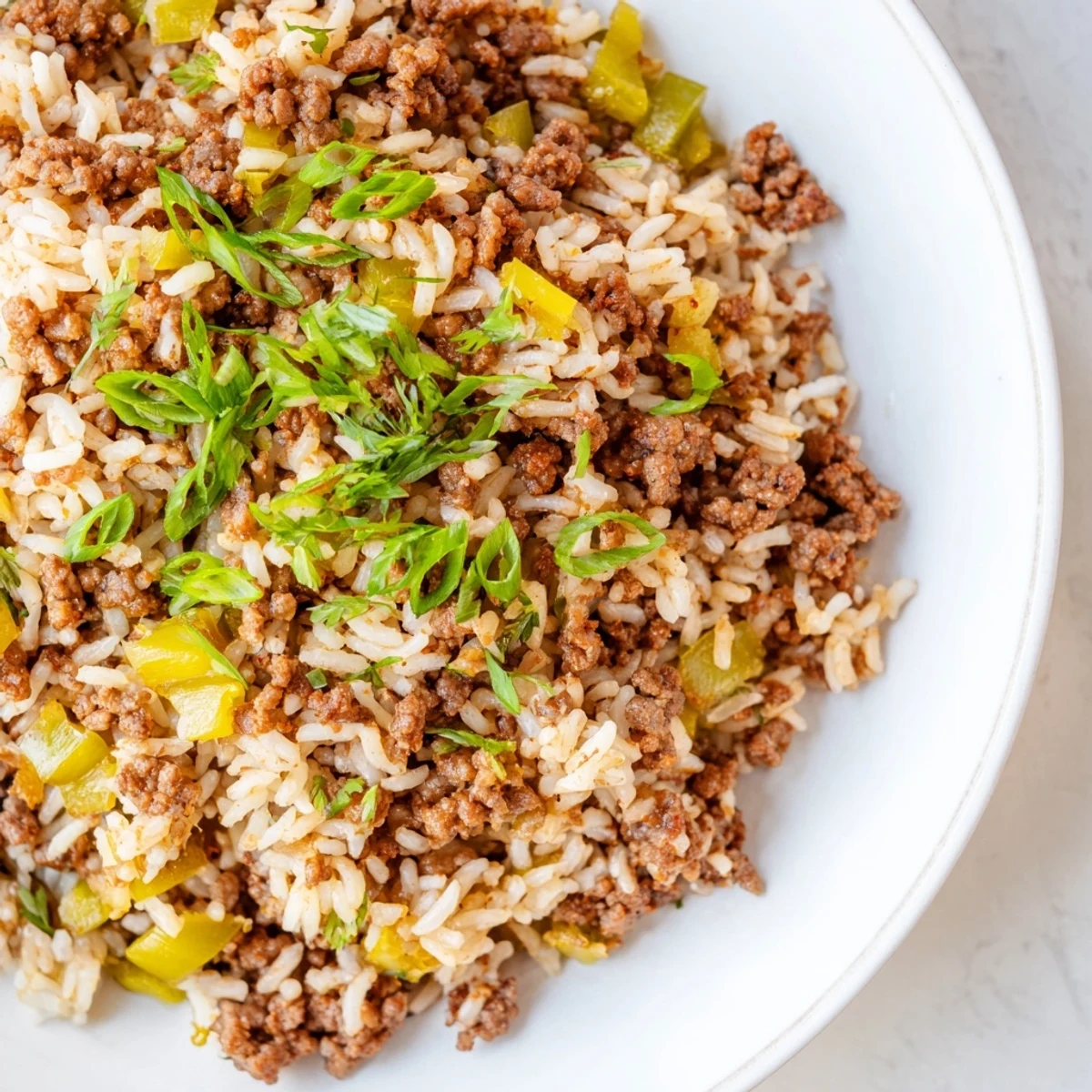 Cajun Dirty Rice with ground beef, served hot and garnished with fresh parsley on a plate.