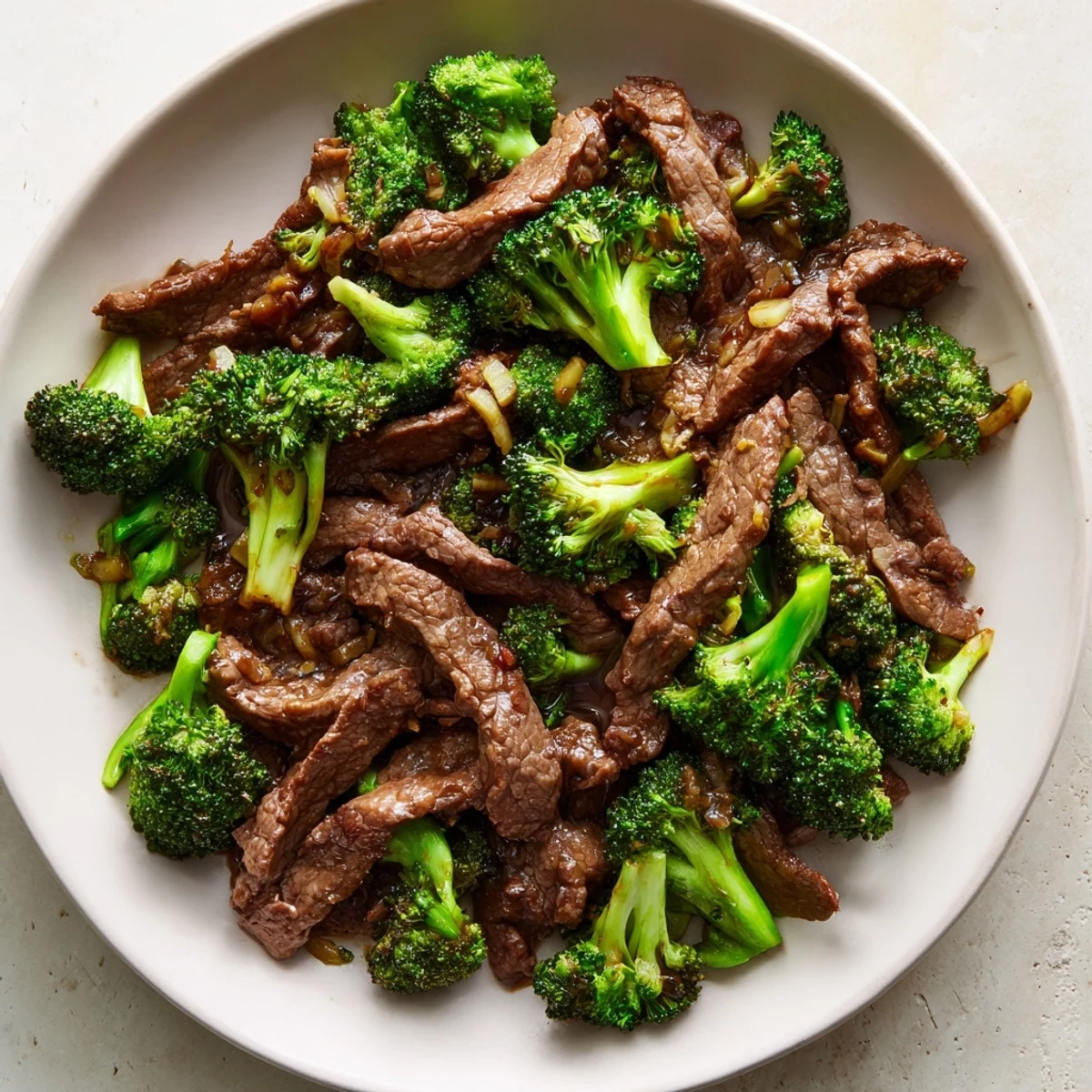 Savory Asian-inspired Beef and Broccoli with a thick, glossy sauce, ready to be enjoyed alongside fluffy steamed rice and chopsticks.