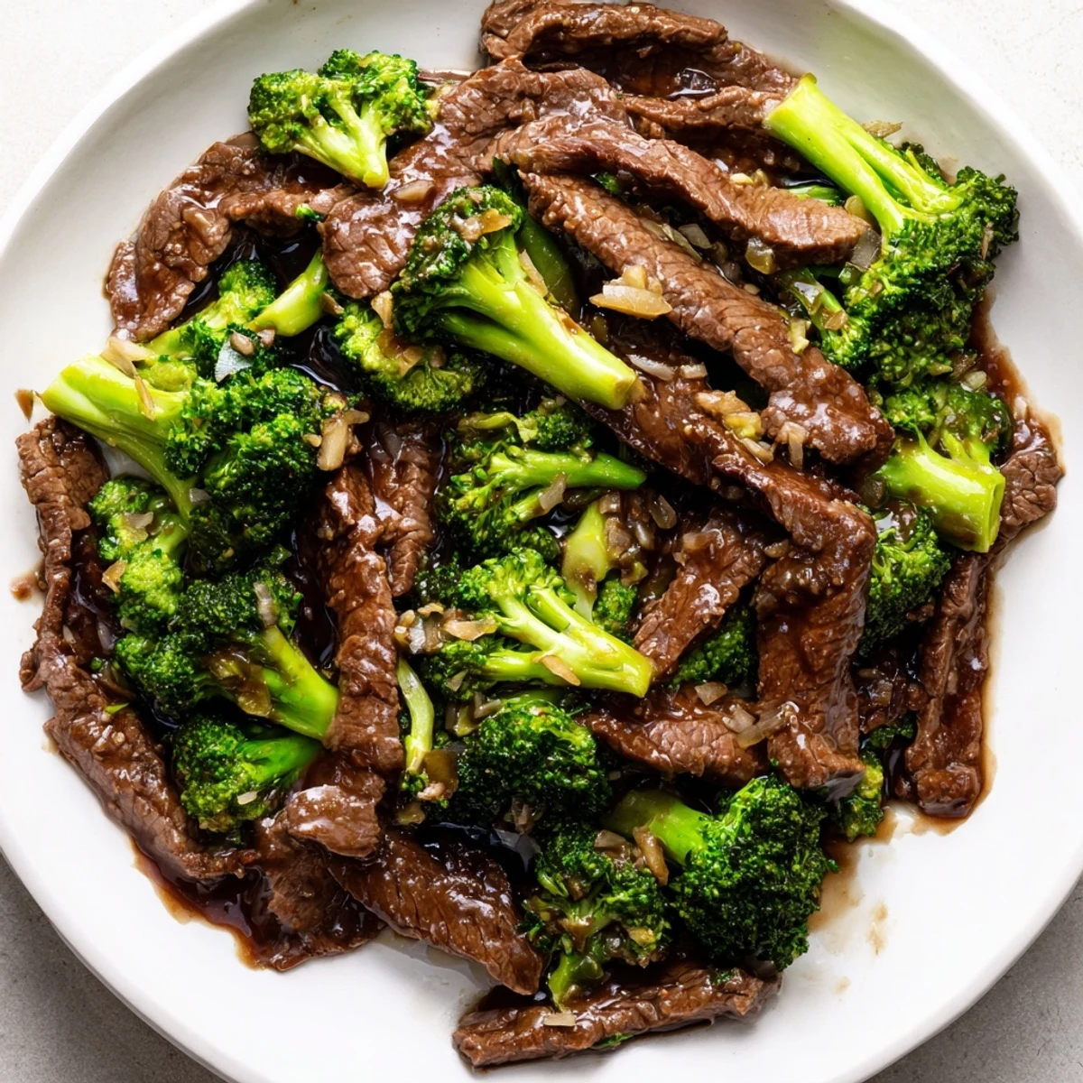 Quick homemade Beef and Broccoli with crisp-tender broccoli and juicy beef slices, perfect for a weeknight dinner with sesame seeds garnish.