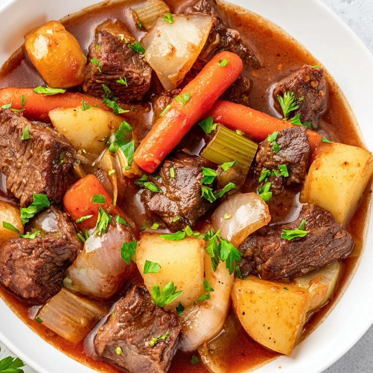 Steam rises from a hearty serving of Slow Cooker Beef Stew with Root Vegetables, garnished with fresh parsley for a bright finish.