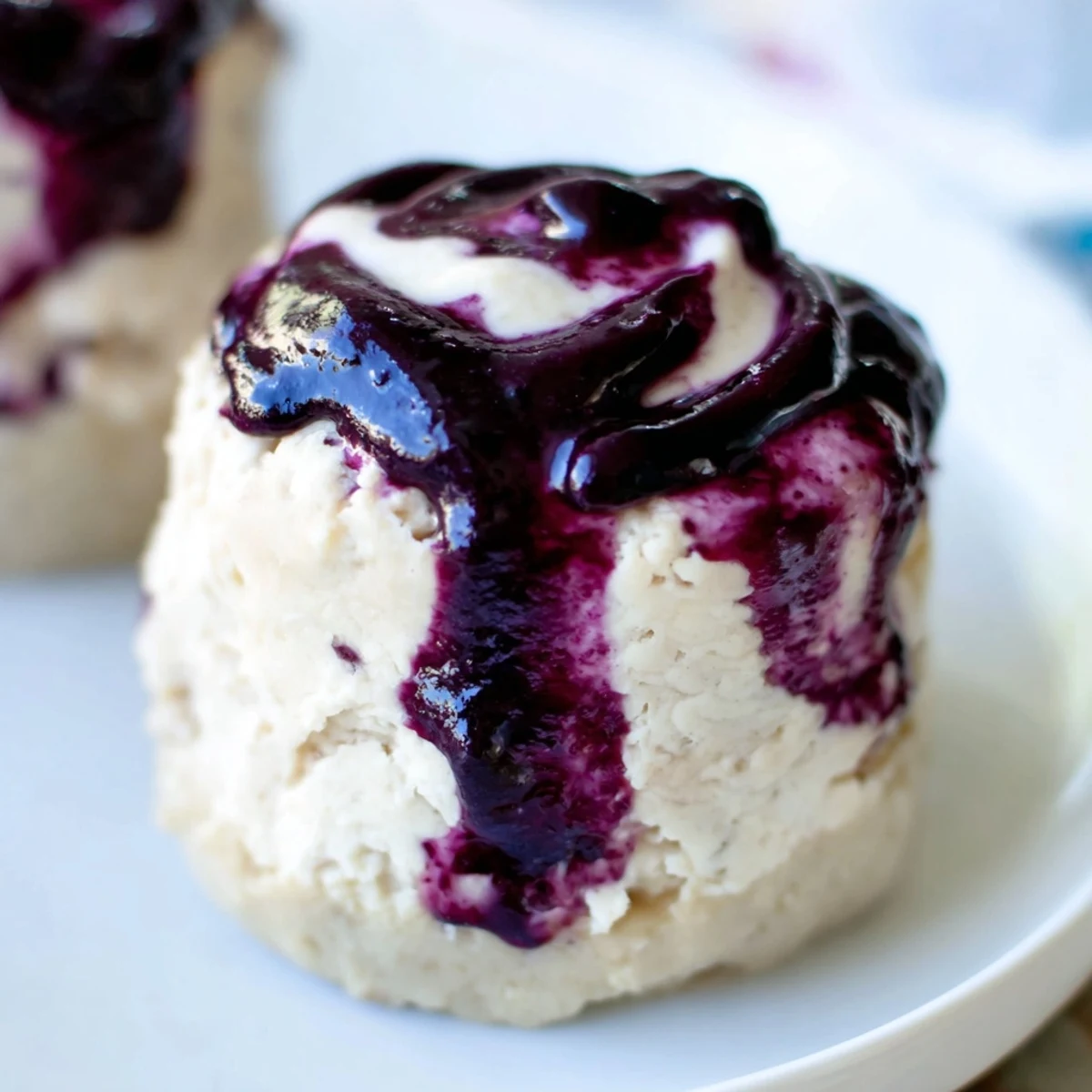 A top-down view of no-bake Blueberry Cheesecake Protein Bites served on a white plate, perfect for healthy snacking.