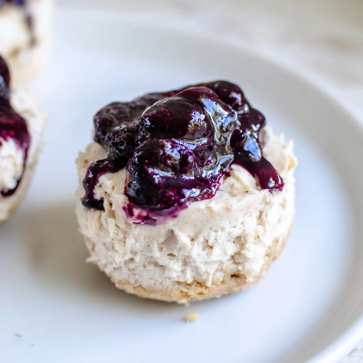 Close-up shot of Blueberry Cheesecake Protein Bites displaying the sweet blueberry compote and soft cheesecake filling texture.