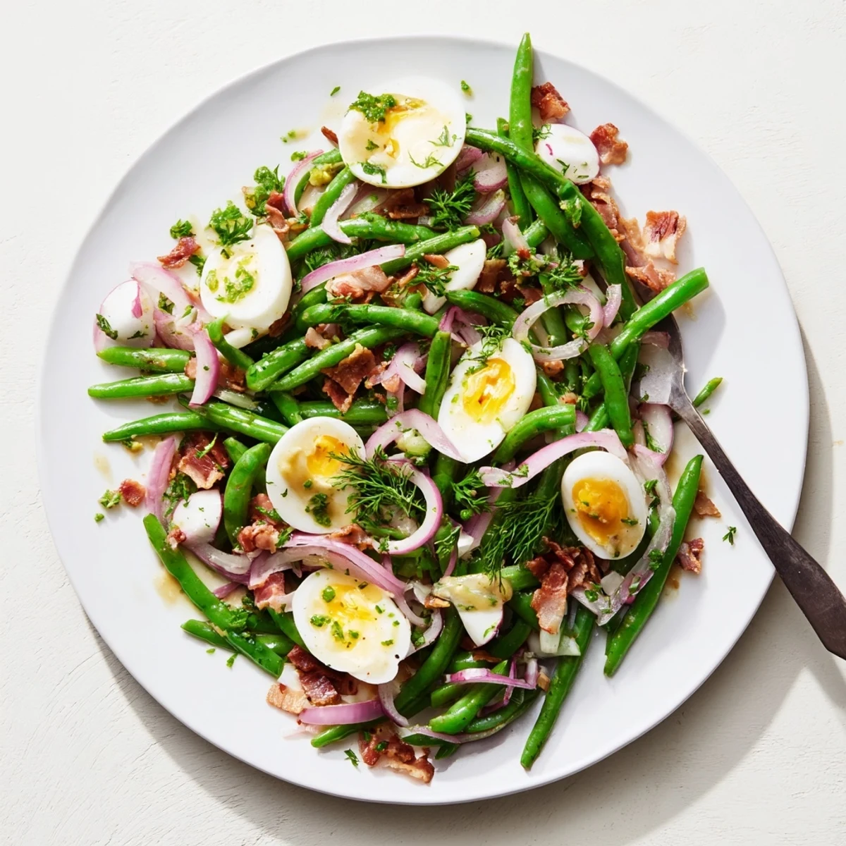 Ready-to-serve Green Bean, Bacon, and Egg Salad garnished with fresh parsley, arranged on a platter for a light American lunch.