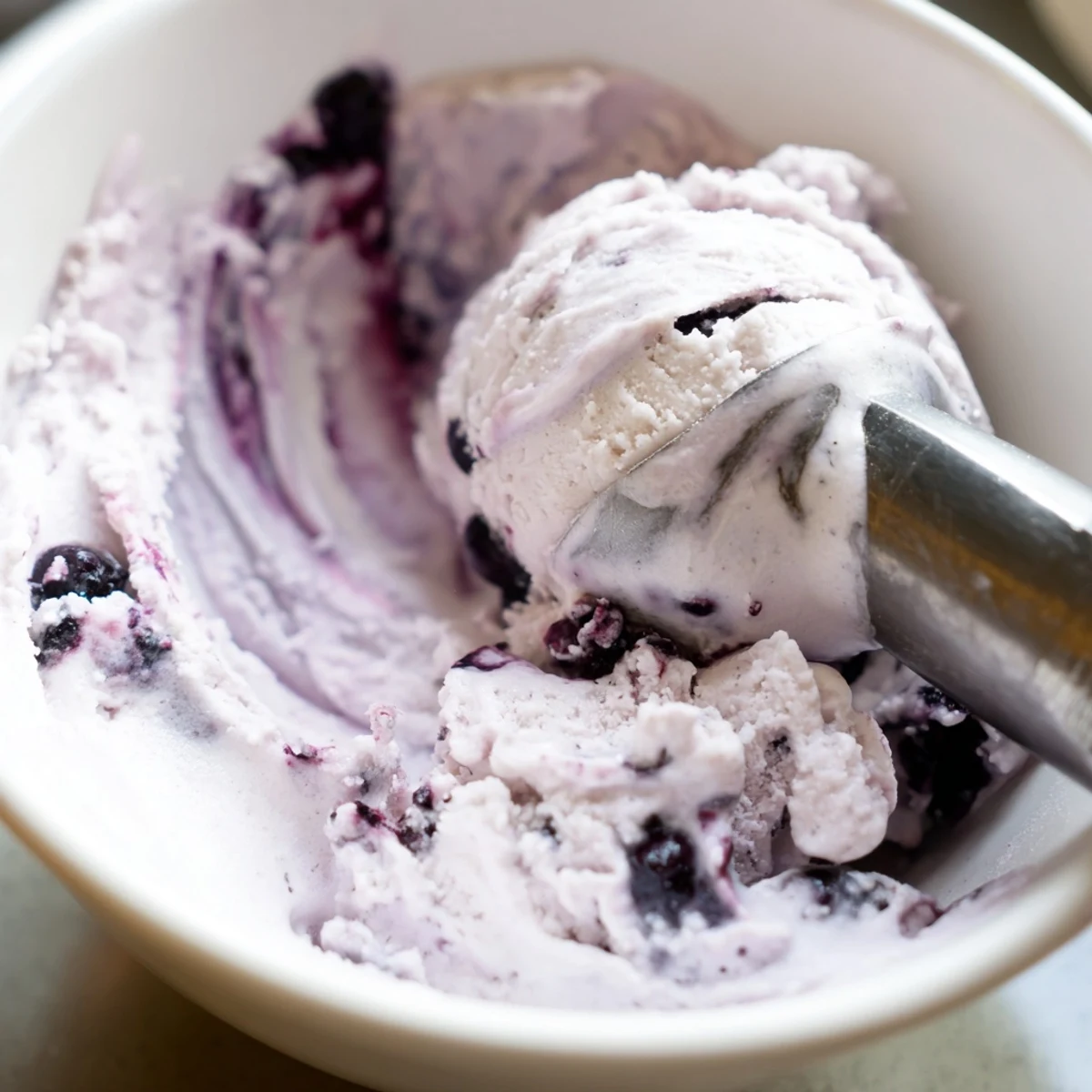 Creamy Blueberry Cottage Cheese Ice Cream with fresh blueberries swirled into a protein-packed frozen treat, ready to serve in scoops.