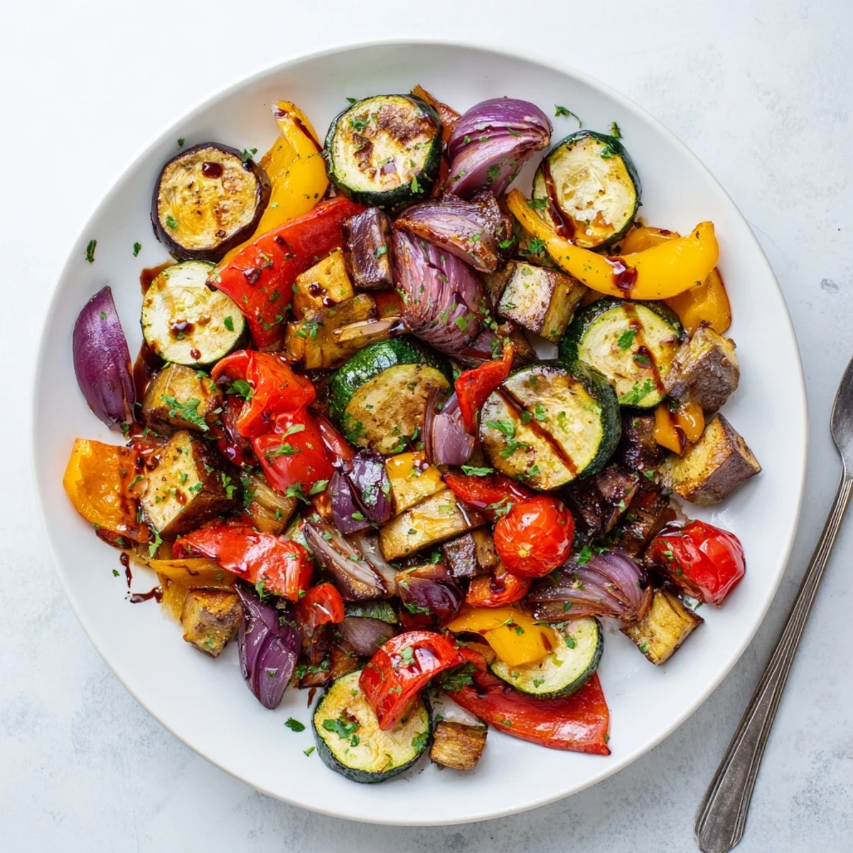 Roasted Italian Roasted Vegetables with juicy tomatoes and onion wedges, ready to enjoy as a healthy side dish.