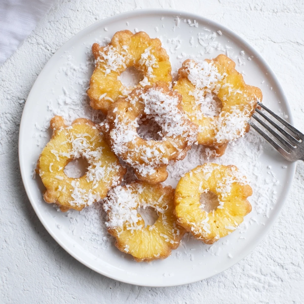 Golden Heavenly Pineapple Fritters sizzling in oil, coated in crispy batter and ready to serve.
