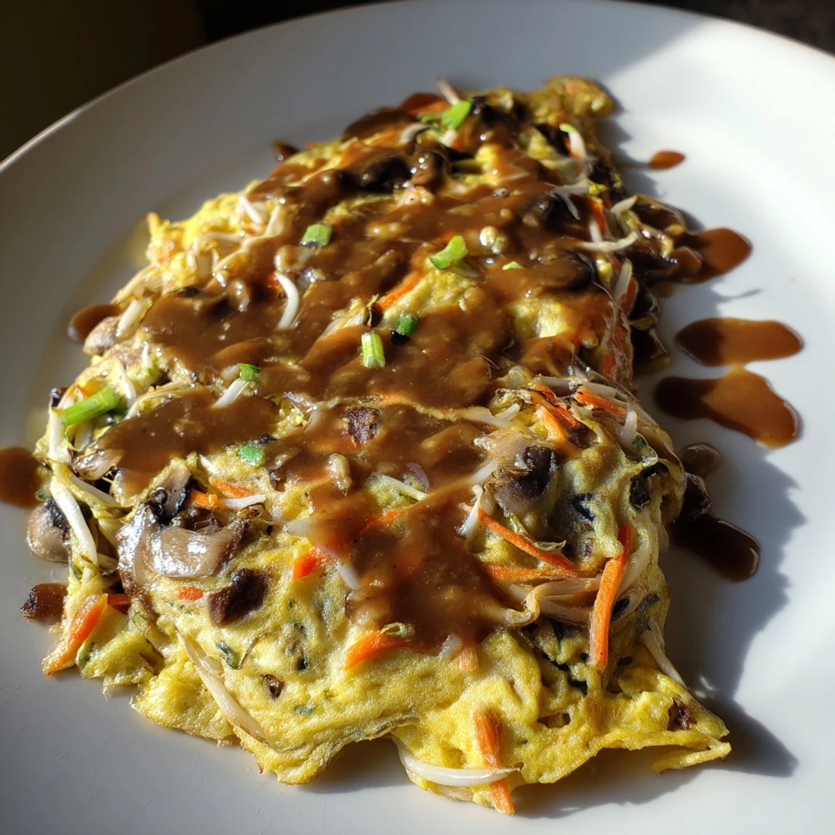 Fluffy vegetable-packed Egg Foo Young omelet fried until perfectly golden brown