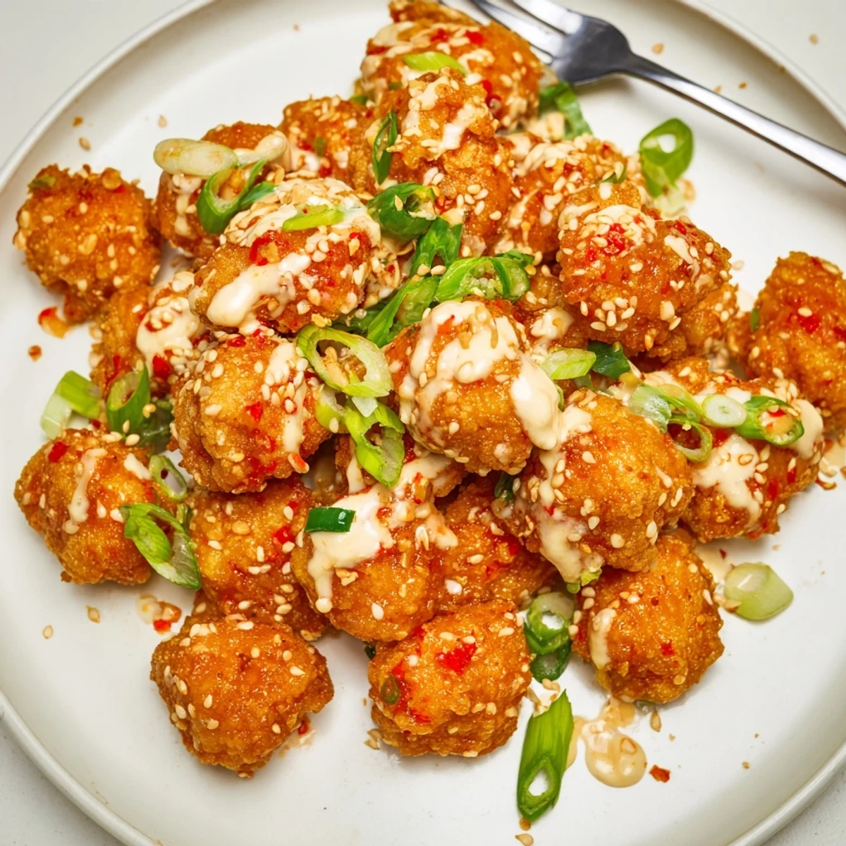 Crispy fried Spicy Bang Bang Chicken tossed in sweet chili Sriracha sauce with fresh cilantro