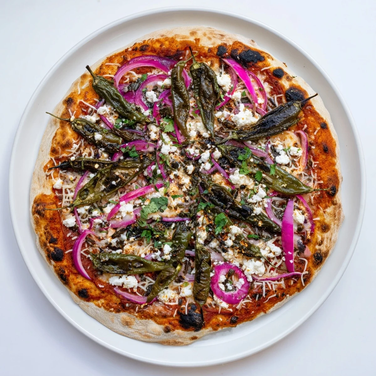 Spicy Poblano pizza topped with charred peppers, red onion and queso fresco cheese