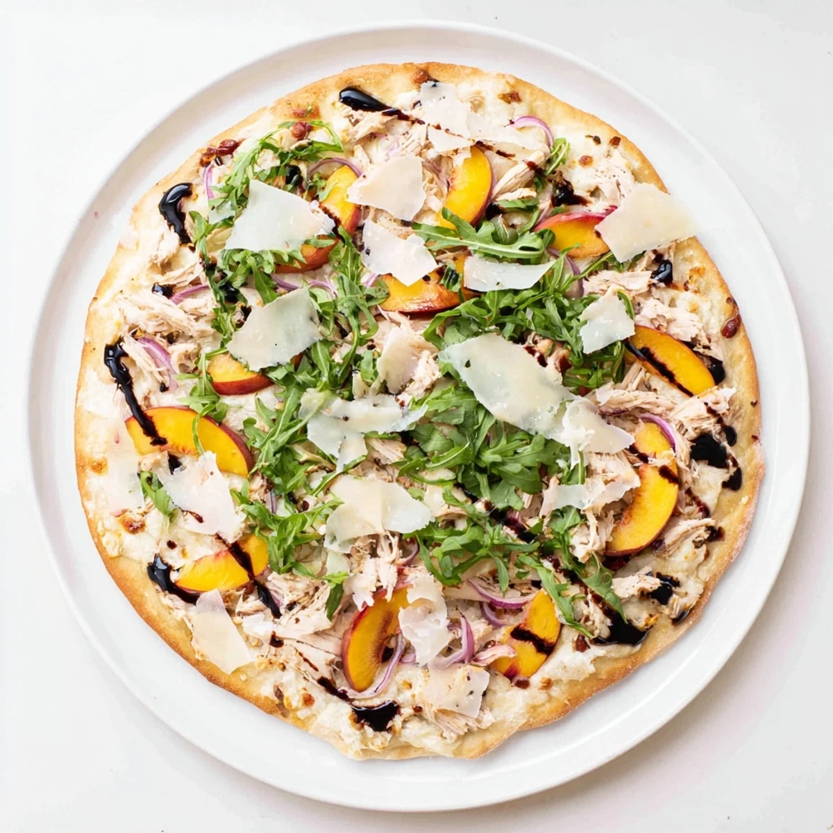 Summer Chicken Peach Ricotta Pizza bubbling with mozzarella and juicy peach slices on crisp crust