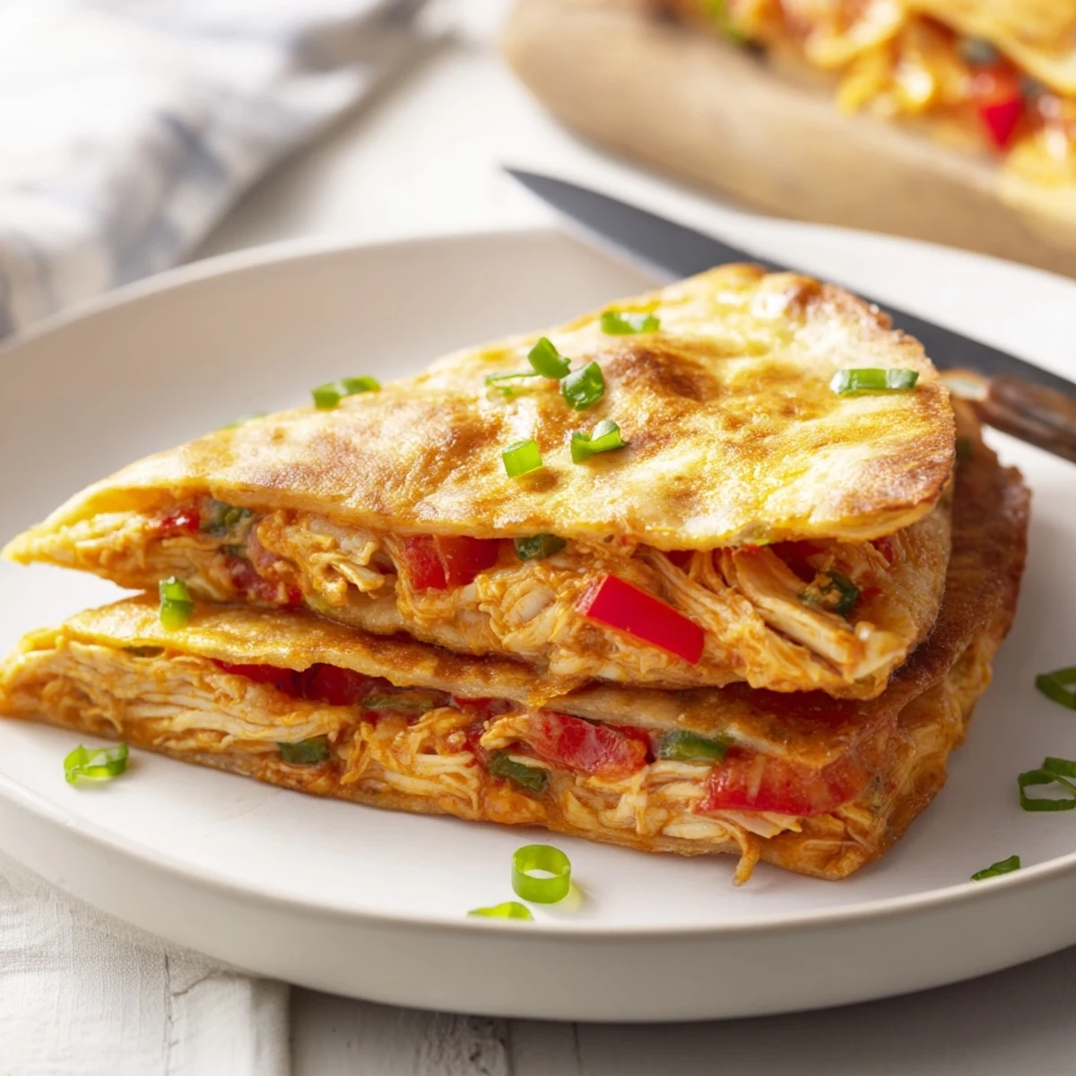Easy baked chicken and cheese quesadillas served with salsa and sour cream garnish