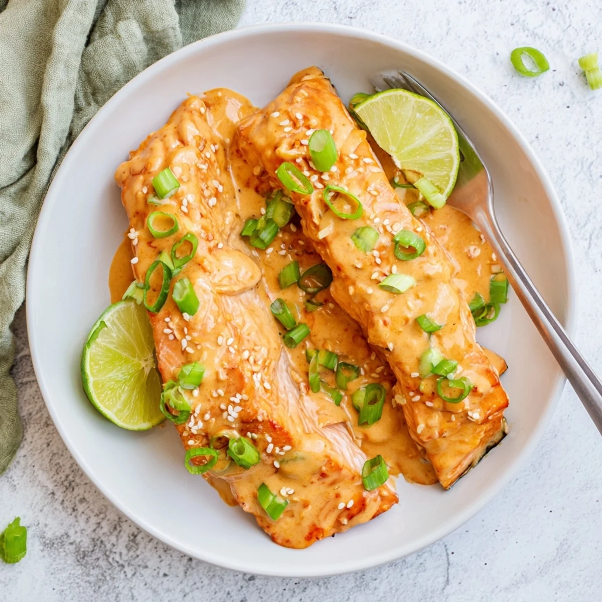 Tender oven roasted salmon topped with homemade Bang Bang sauce drizzled over the perfectly cooked flaky fish