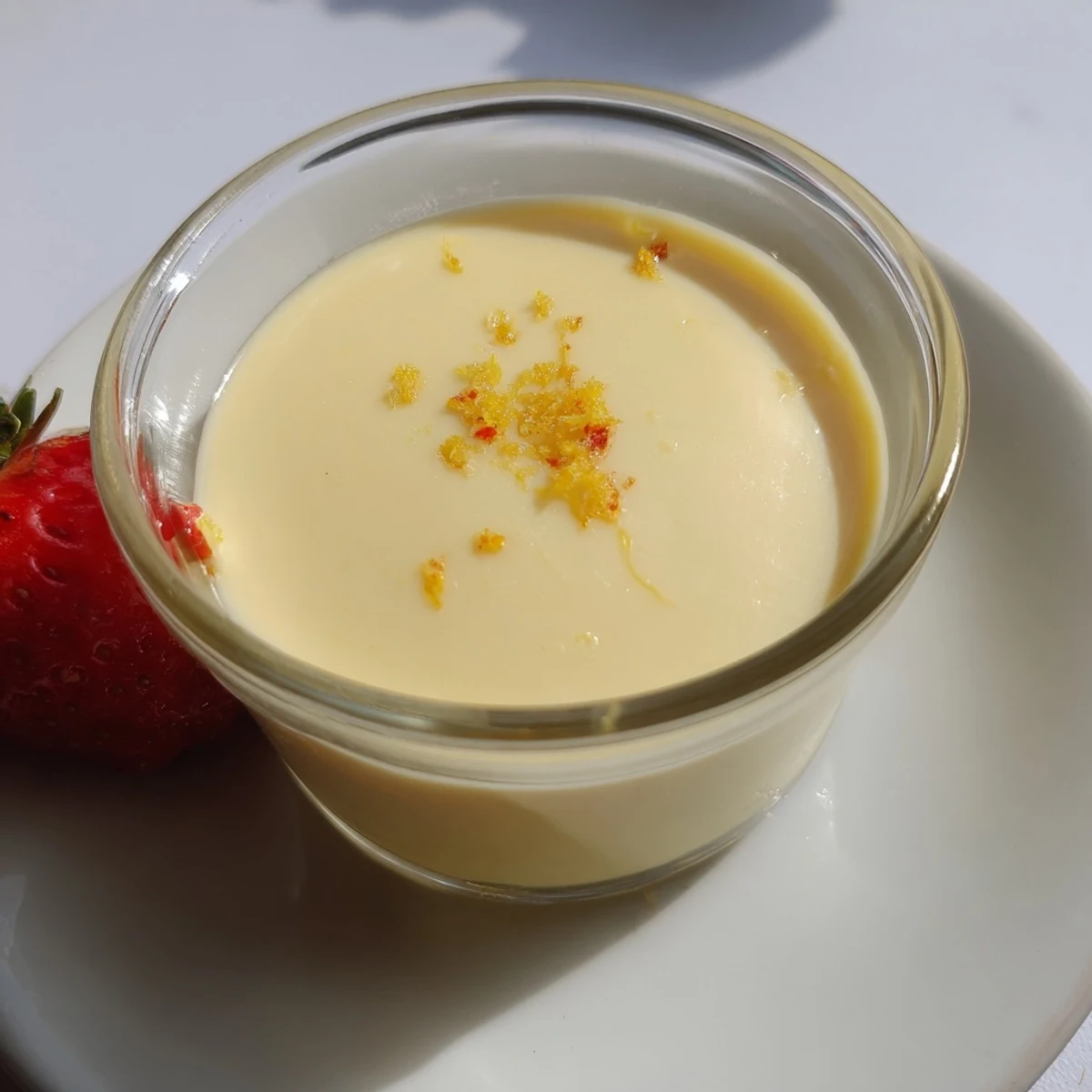 Golden lemon posset with bright citrus garnish ready for serving after proper chilling