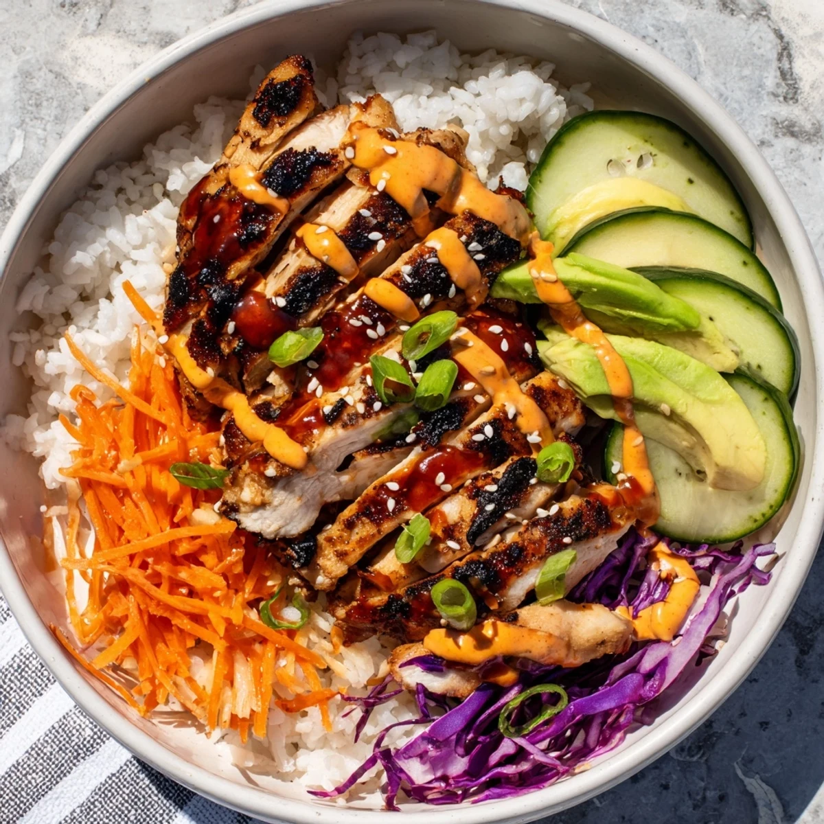 Golden grilled Korean BBQ chicken bowls with colorful vegetables and spicy gochujang mayo drizzled over fluffy white rice
