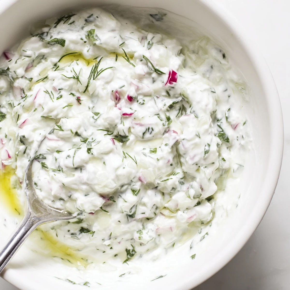 Crisp grated radishes and cucumbers folded into thick Greek yogurt for this refreshing Mediterranean healthy radish tzatziki dip