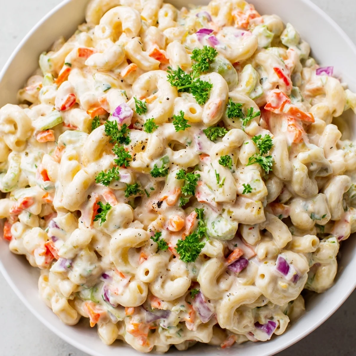 Crowd-pleasing macaroni salad with crunchy red peppers and celery in a zesty creamy dressing