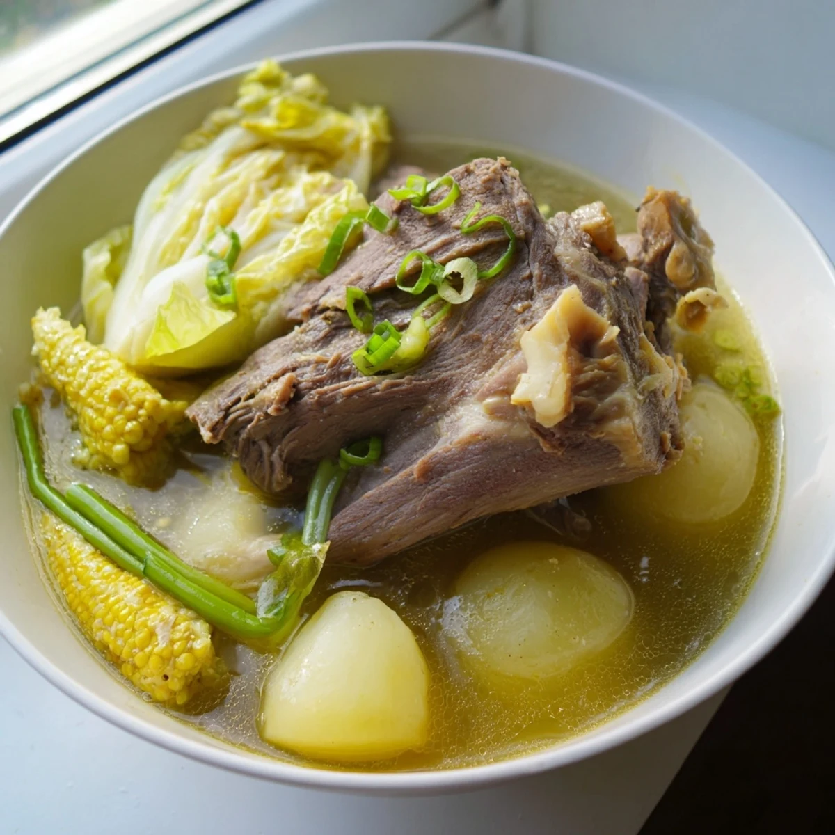 Filipino Bulalo beef shank soup with corn cabbage and rich clear broth