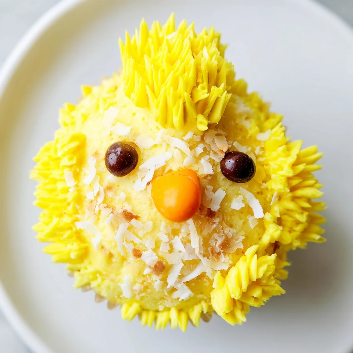Adorable Easter Chick Cupcakes with fluffy yellow frosting and sweet candy faces on a springtime dessert plate.
