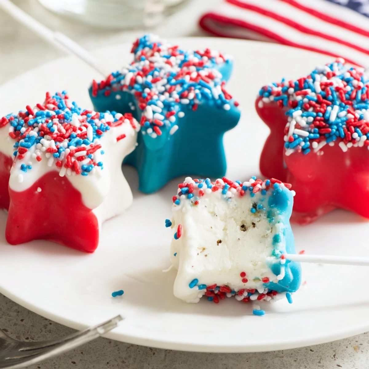 Handheld Fourth Of July Star Cheesecake Pops chilled, sprinkled, perfect for picnic desserts.