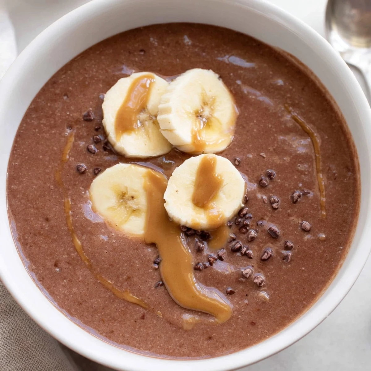 Chocolate Peanut Butter Banana smoothie with silky chocolate swirl and banana slices