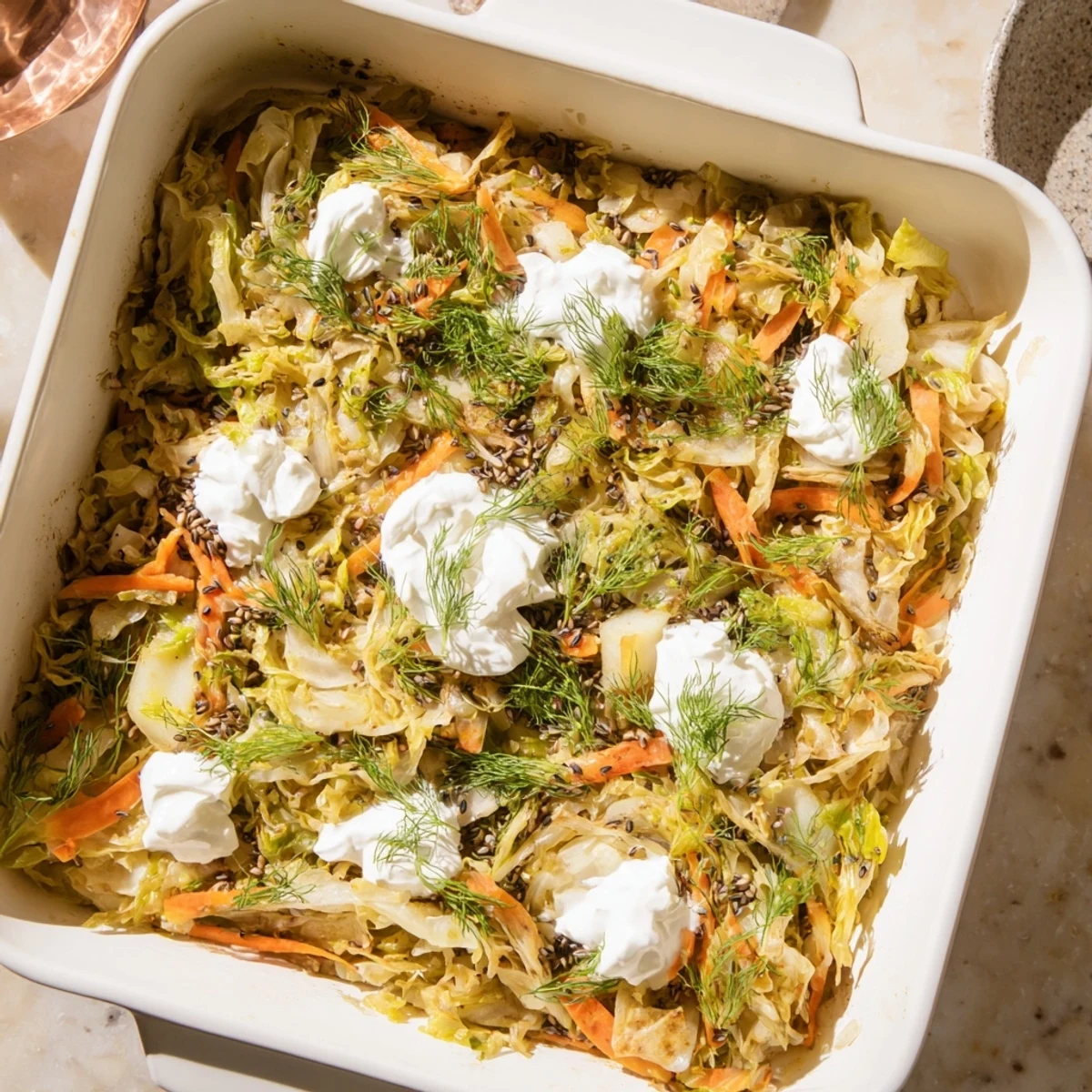 Hearty German style cabbage casserole bubbling in dish with tender layered vegetables and caraway
