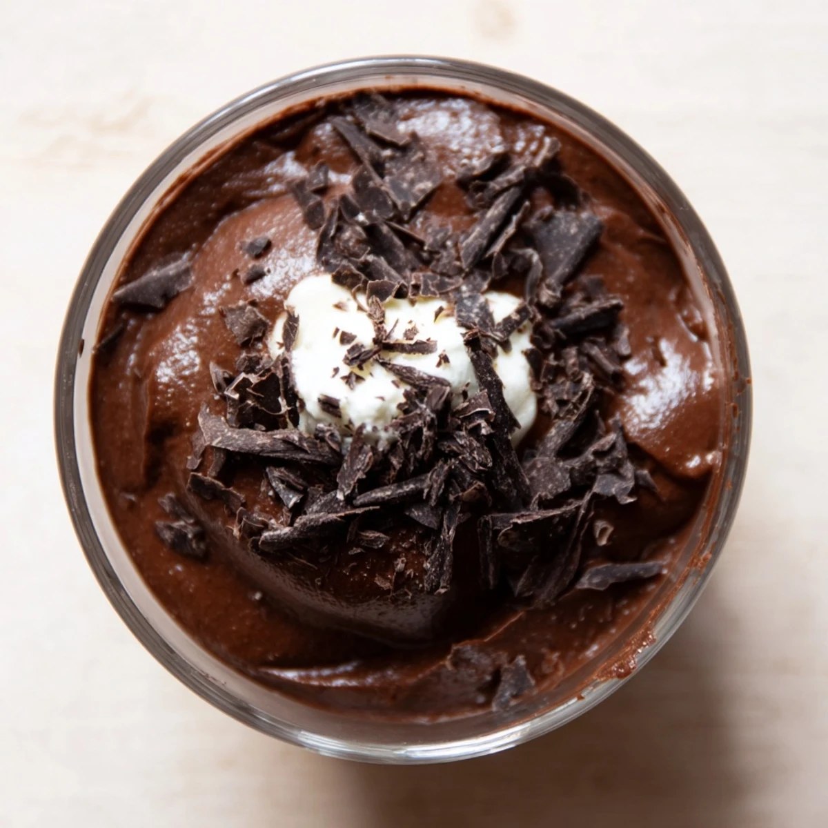 Velvety chocolate mousse served in elegant glasses topped with delicate chocolate shavings